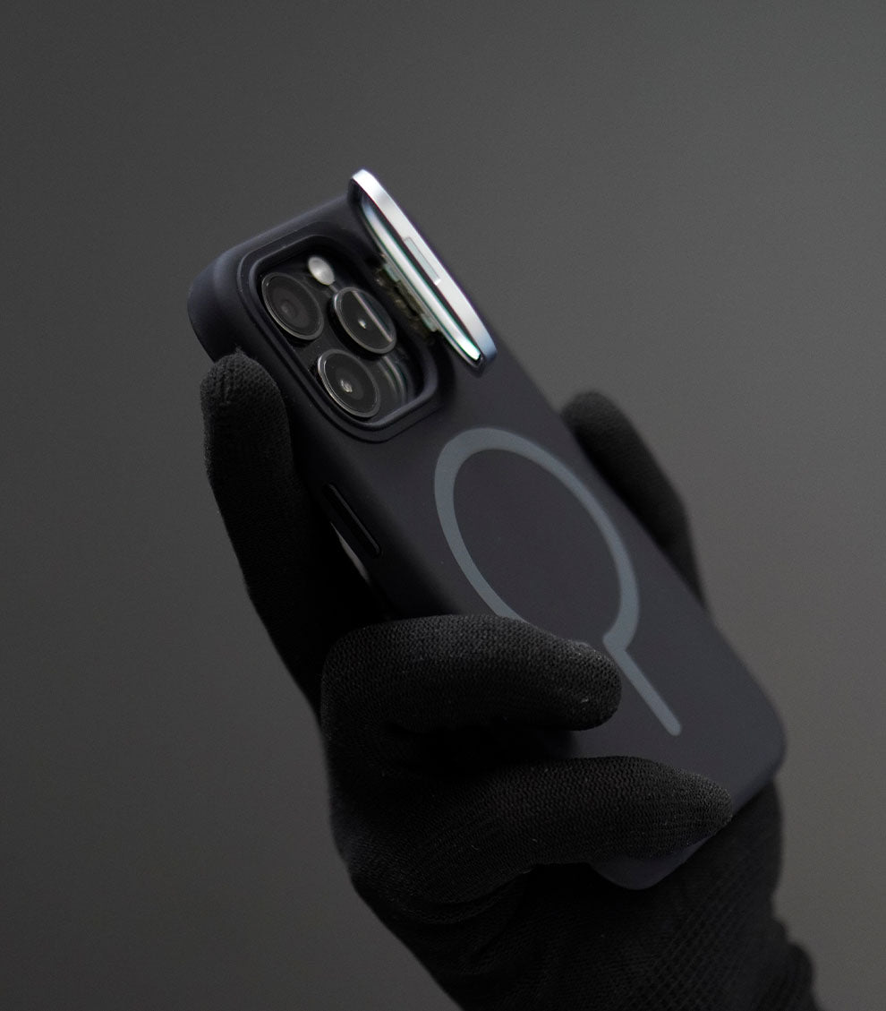 Soft-touch black silicone MagSafe case held by gloved hand, exuding elegance